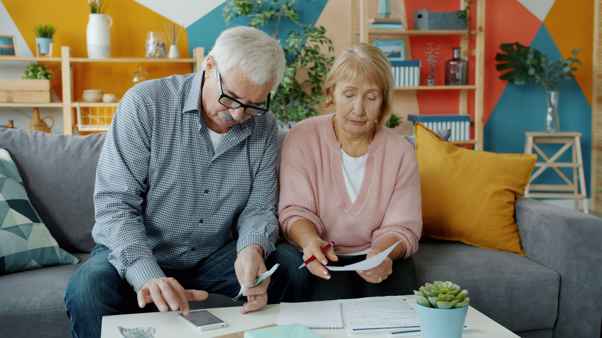 Older couple reviewing financial paperwork at home